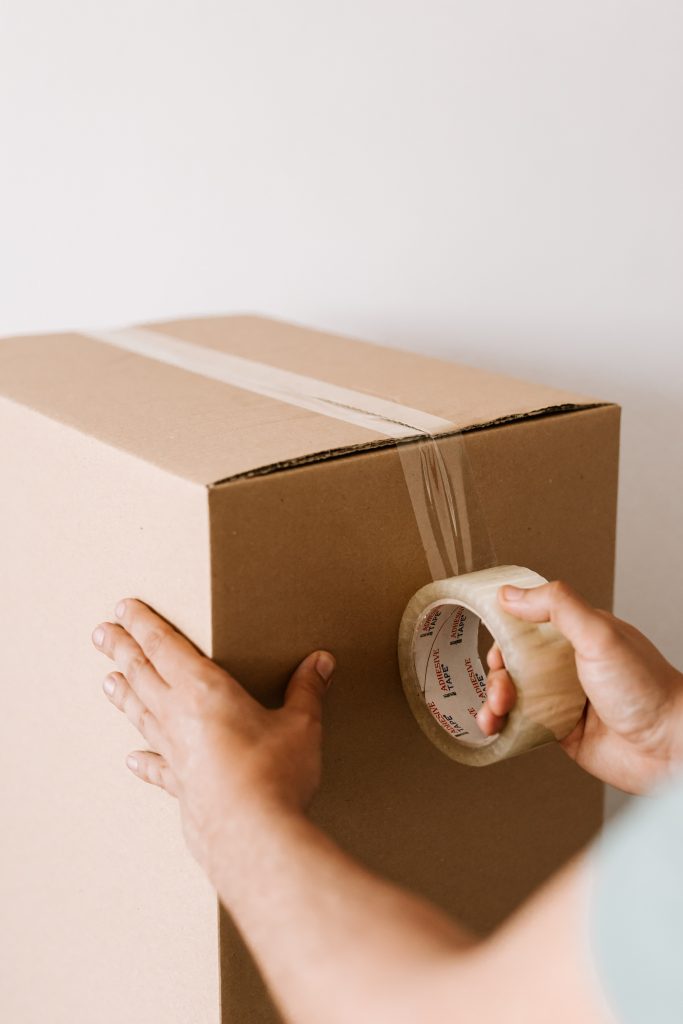 Person packing a box